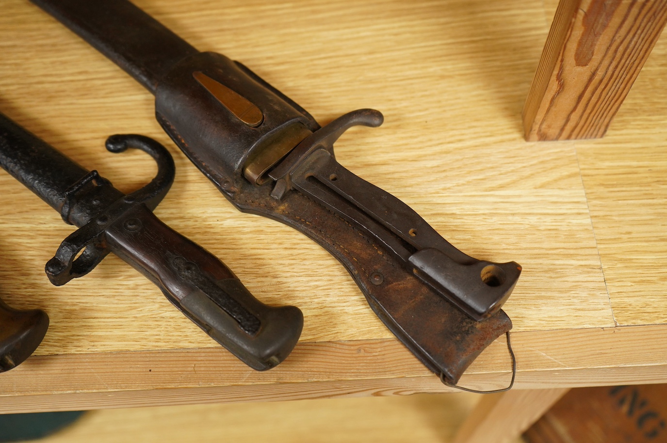 Seven bayonets; a speculative 20th century English bayonet of unknown type with broad arrow and other English type markings, together with a German butcher bayonet in scabbard (grips missing), a Gras bayonet and scabbard